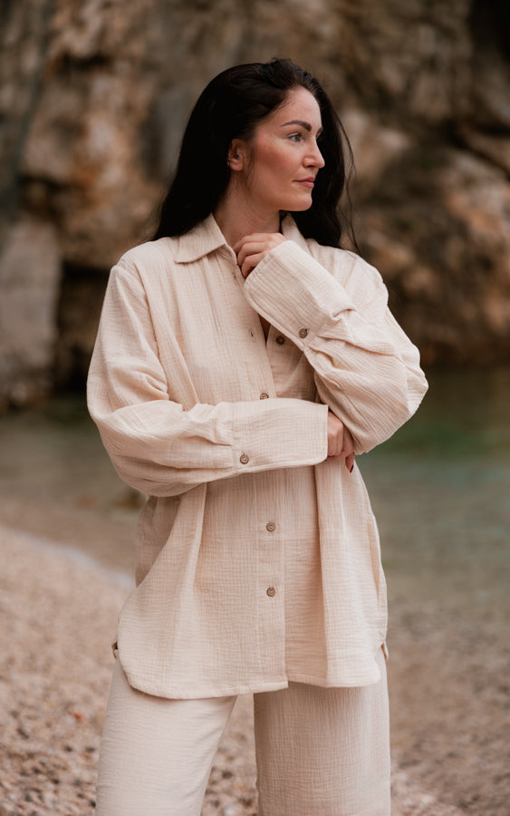 Woman wearing the sand Coconut matching set with an oversized shirt and wide-leg pants