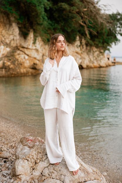 Woman wearing the white Coconut organic cotton matching shirt and pants set by Bohème by Ena