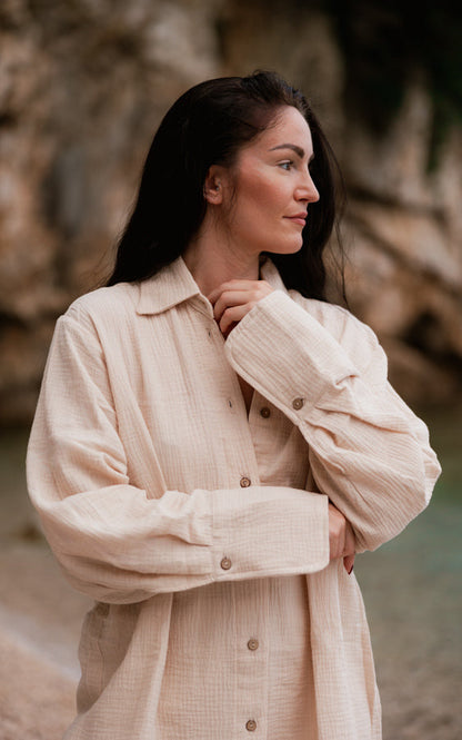 Woman wearing the sand Coconut oversized organic cotton shirt with natural buttons