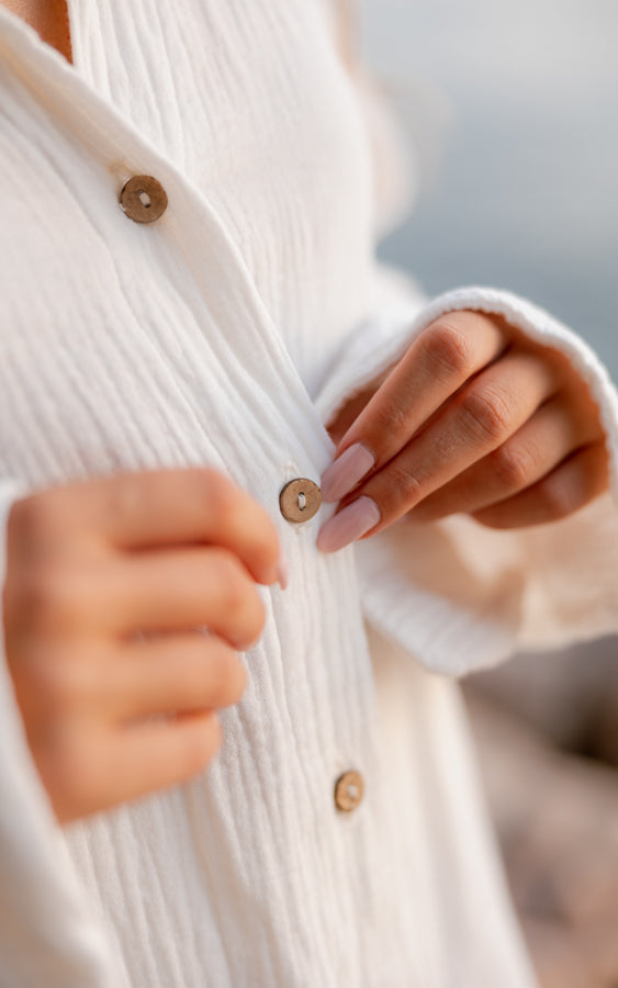 Close-up of natural coconut buttons on the white organic cotton Coconut shirt