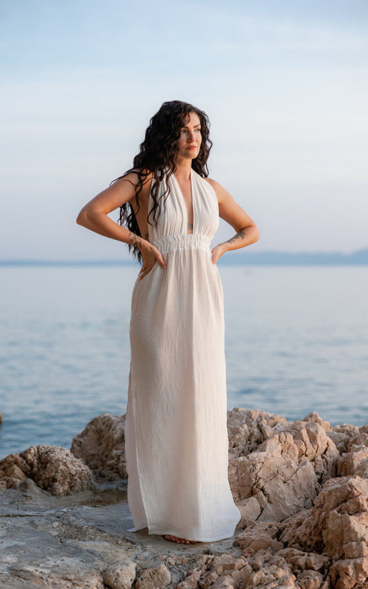 Woman wearing the white Mayan Goddess Maxi Dress by Bohème by Ena by the sea