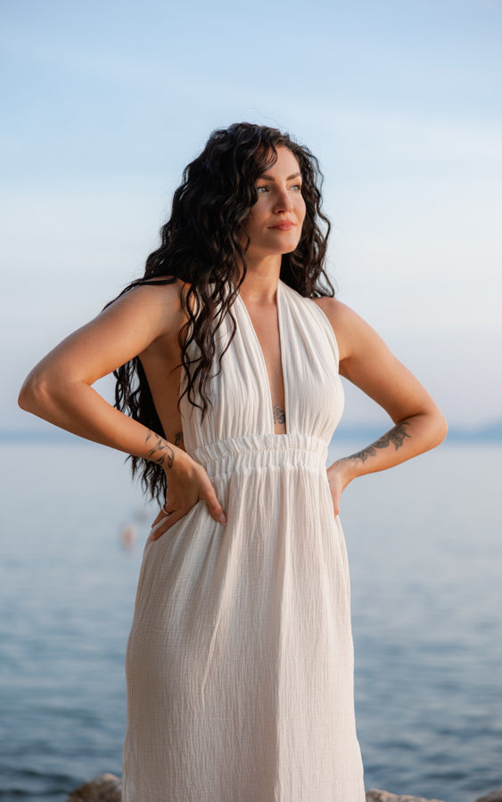Front view of the white Mayan Goddess Maxi Dress styled by the sea