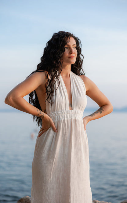 Front view of the white Mayan Goddess Maxi Dress styled by the sea