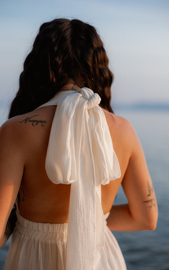 Back view of the white Mayan Goddess Maxi Dress showing the open-back design