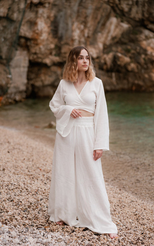 Woman wearing the white Mexico Bohemian Set on a rocky beach in Croatia