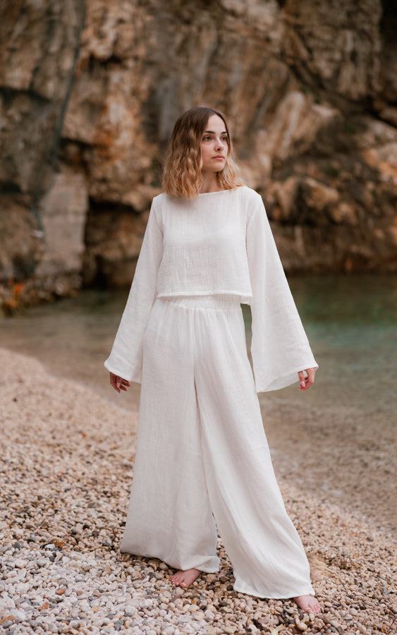 Woman wearing the white Oasis organic cotton matching set with wide-leg pants by Bohème by Ena