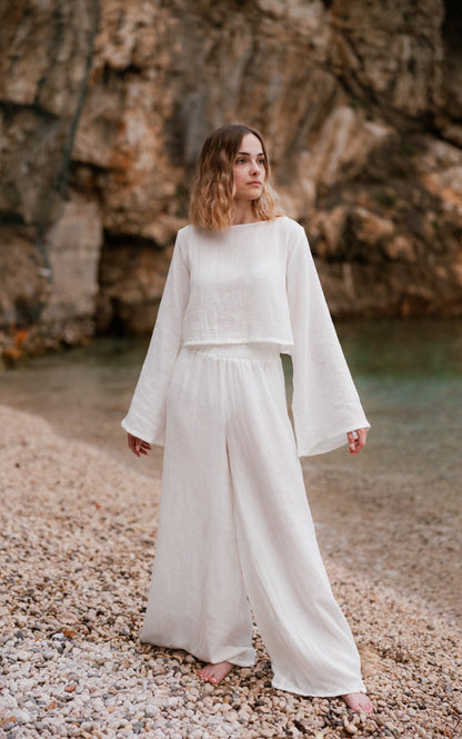 Woman wearing the white Oasis organic cotton matching set with wide-leg pants by Bohème by Ena