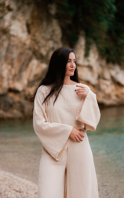Woman wearing the sand Oasis matching set featuring flowing wide sleeves and organic cotton fabric