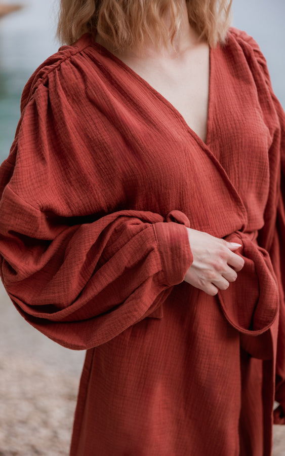 Close-up of terracotta Bohème by Ena resort kimono with statement puffy sleeves and waist tie