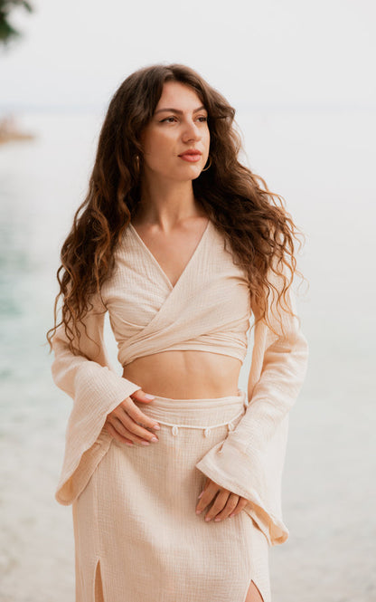 Woman wearing the sand Tulum Matching Set with wrap top and maxi skirt